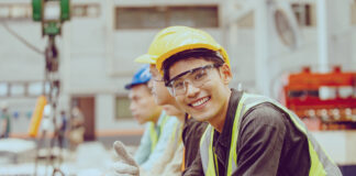 Ein Mitarbeiter in der Produktion lächelt.