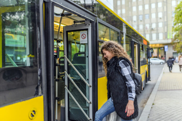 Eine junge Frau steigt in den Bus