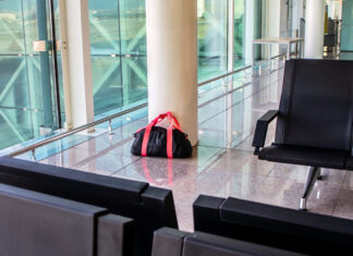 Eine schwarze Tasche steht am Flughafen.