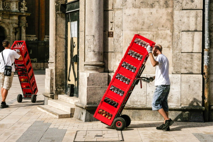 Stapel mit Getränkekisten werden transportiert.