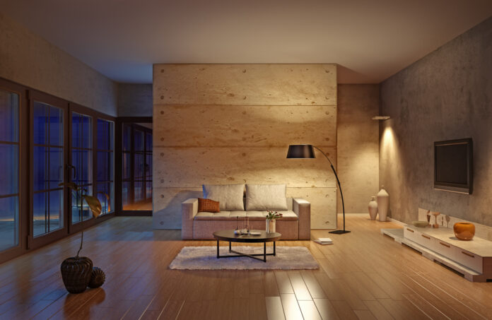 Ein sehr modern eingerichtetes Wohnzimmer in Beige mit Fernseher, Sofa, Lampe, Tisch und anderen Möbeln.