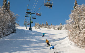 Mehrere Skifahrer fahren die Schneepiste hinab.