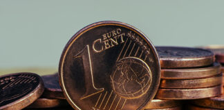 Auf einem Tisch liegen viele 1 Cent Münzen.