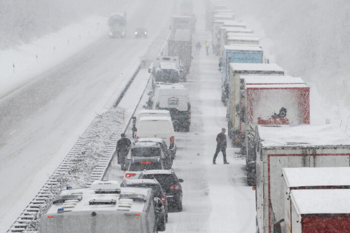 Autos stehen im Winter auf der Autobahn im Stau.