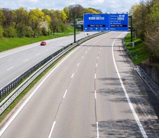 Eine leere Autobahn mit großen Schildern.
